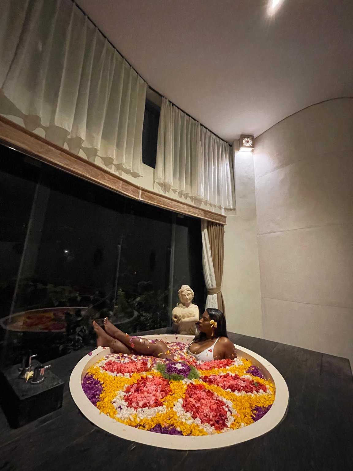 Nicci enjoying a restorative flower bath during a luxury wellness experience